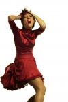 Woman in red dress holding her head and screaming
