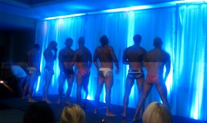 Men standing on stage in their underwear for the underwear charity auction